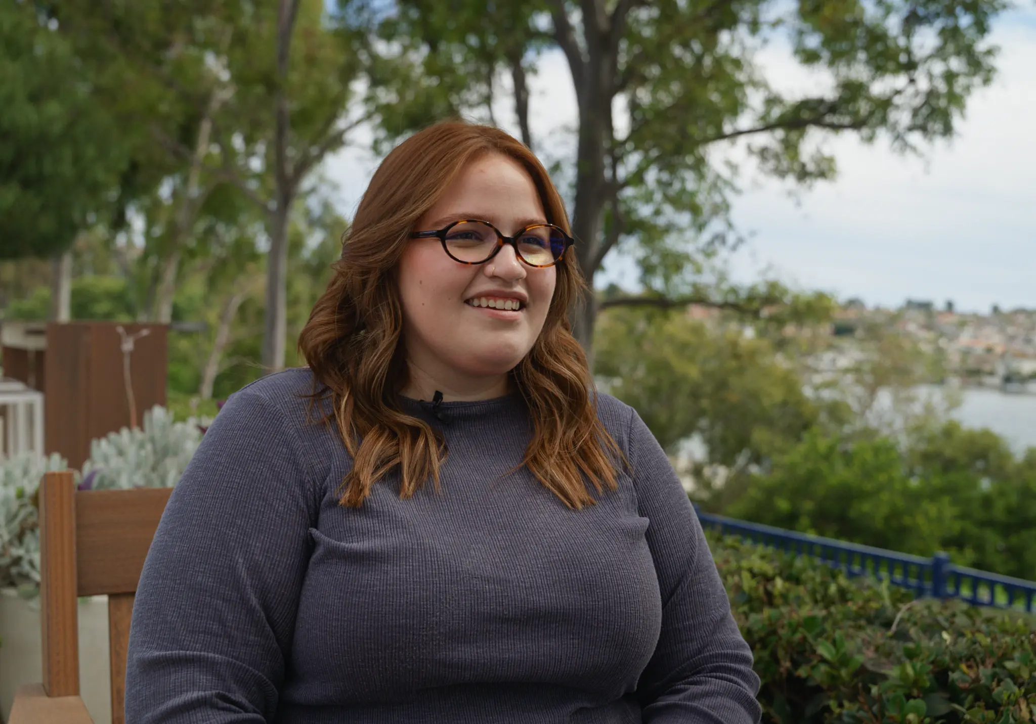 Ashley sharing her testimony outdoors overlooking the water.