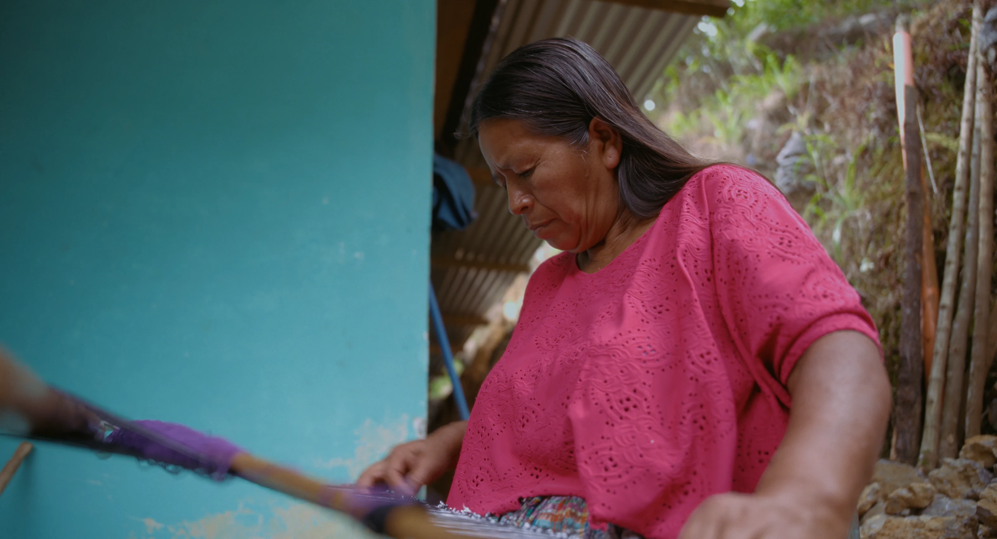 A woman painting at home in Guatemala.